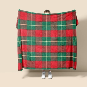 Detail of soft red and green plaid flannel blanket texture for Christmas home decor