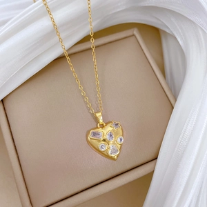 Luxurious gold heart pendant necklace with shimmering zircon stones on beige silk background