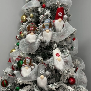 Set of 6 Christmas gnome plush ornaments with reindeer antlers on a snowy tree