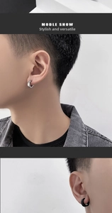 Close-up of classic silver and black titanium steel ear clips in a minimalist hoop style
