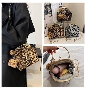 Detail of leopard print plush handbag with metal handle, gold chain and interior view