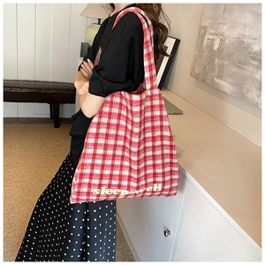 Detailed side view of large red checkered tote bag with Sleep Well printed text