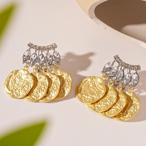 Boucles d'oreilles bicolores géométriques avec strass brillants et texture dorée martelée