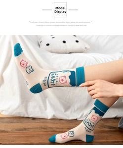 Detailed view of Japanese style socks with cartoon bear patterns and milk bottle design