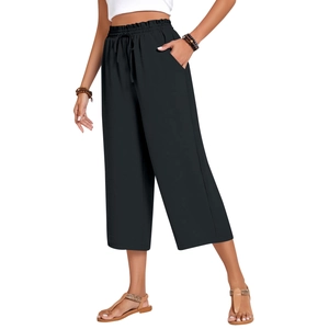 Detailed view of elastic high waist with drawstring and side pockets on black linen pants