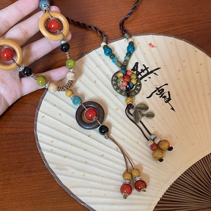Ethnic ceramic beaded necklace with wooden rings and bronze leaf pendant for women