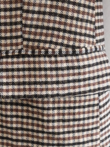 Detailaufnahme von braunem Hahnentritt-Wollstoff und präziser Taschenverarbeitung