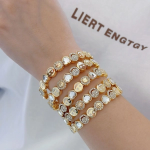 Elegant gold multi-layer bracelet with heart crystals and smiling face charms on wrist