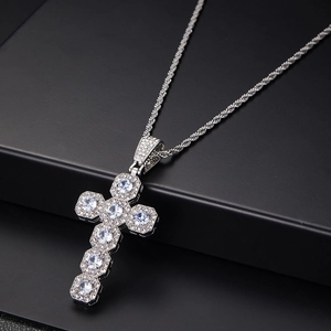 Detail of silver twisted chain necklace featuring a crystal-inlaid cross pendant