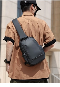 Rear view of waterproof nylon chest bag worn diagonally on back in urban street setting