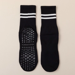 Black non-slip yoga crew socks with white stripes and hexagonal grip soles for pilates