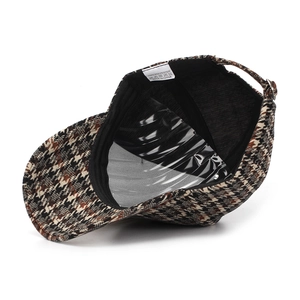Detail of wool houndstooth baseball cap featuring 100% polyester fabric and metal buckle