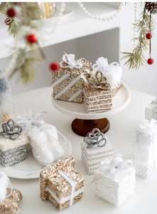 Champagne and white Christmas gift box ornaments with glitter and festive ribbons