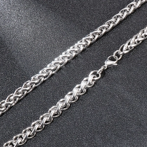 Detail of silver stainless steel wheat chain showing polished texture and lobster clasp