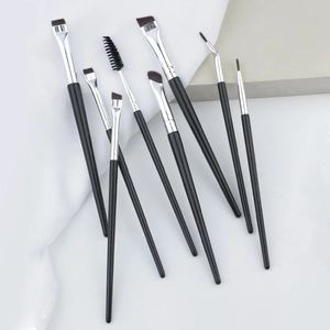 Macro shot of 8 professional eye makeup brushes including eyeliner and brow brush tools