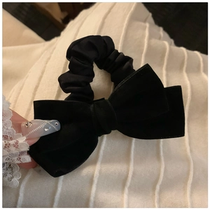 Handmade black velvet scrunchie with large bow in French vintage style on wrist