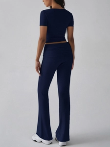 Full back view of a navy blue Y2K style cropped t-shirt and flared trousers set