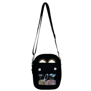 Detail of black ita bag featuring a transparent PVC window and adjustable shoulder strap