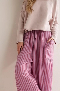 Close-up of pink striped wide-leg trousers with drawstring elastic waist and side pockets