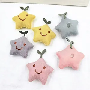 Padded fabric star accessories with embroidered smiley faces in multiple pastel colors