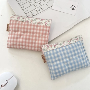 Quilted cotton pouches in blue and pink patterns for organizing pads and daily items