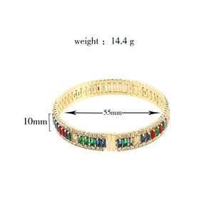 Close-up of golden bracelet with colorful zircons showing 55mm inner diameter dimensions