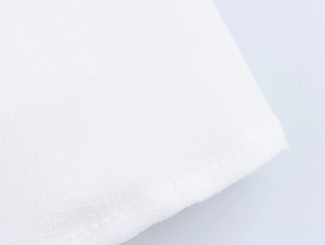 Macro view of white cotton-linen fabric texture with durable hemmed stitching detail