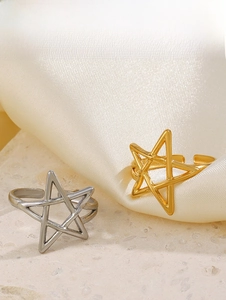 Detail of adjustable star cutout rings in gold and silver finish on silk and stone