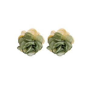 Macro detail of handmade layered lace rose earrings in vintage green and yellow tones