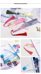 Detailed view of DIY resin bookmarks with gold foil, glitter, and matching silk tassels