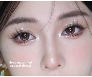 Detail showing natural sunflower wispy false eyelashes and glitter eyeshadow makeup effect