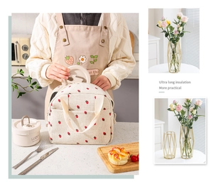 Detail of insulated strawberry corduroy lunch bag featuring thick aluminum foil lining