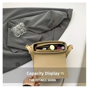 Interior view of beige baguette bag showing main compartment with lipstick and cosmetics