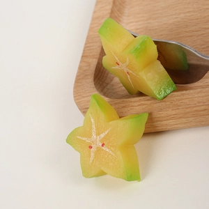 Lifelike PVC starfruit slices accessory with realistic texture on a wooden tray