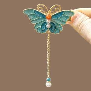 Exquisite enamel butterfly hair clip with teal blue wings, pearls, and gold tassels