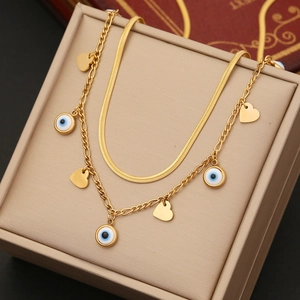 Golden double layer necklace featuring snake chain and evil eye heart pendants