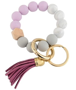 Detail of purple silicone bead keychain with hexagonal wood bead and burgundy suede tassel