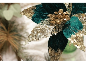 Macro detail of dark green velvet Christmas flower with gold sequins and mesh texture