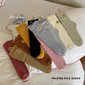 Women's cable knit slouch socks in a multi-color collection with ruffled elastic edges