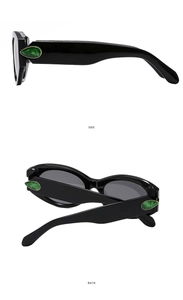 Detail view of black sunglasses with green gemstone accents from side and back angles