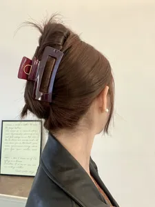 Deep burgundy large rectangular claw clip shown styled on long brunette hair