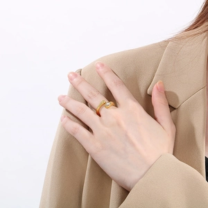 Detail of 18k gold plated snake-shaped wrap ring featuring a clear crystal accent