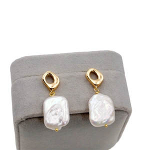 French vintage baroque pearl drop earrings with golden hooks on gray velvet box display