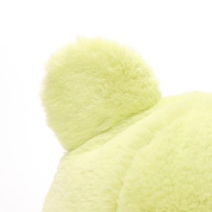 Detailed close-up of soft light green plush faux fur texture on a bucket hat