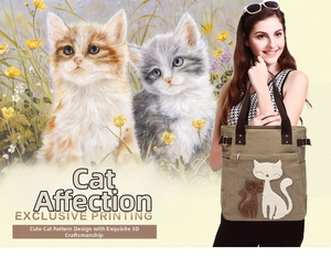 Detailed close-up of a khaki canvas tote bag with embroidered cat motifs and side buckles