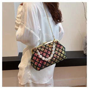Detail of colorful sequined lattice handbag with gold chain and white pearl handle