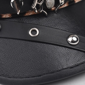 Detail of black PU leather baker boy hat with silver metal spikes and punk style chain