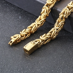 Close-up of gold Byzantine chain necklace showing detailed link weave and lobster clasp
