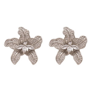Silver flower stud earrings with shimmering cubic zirconia stones on white background