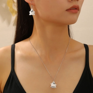 Detail of a cute ghost necklace and earring set worn by a woman for Halloween